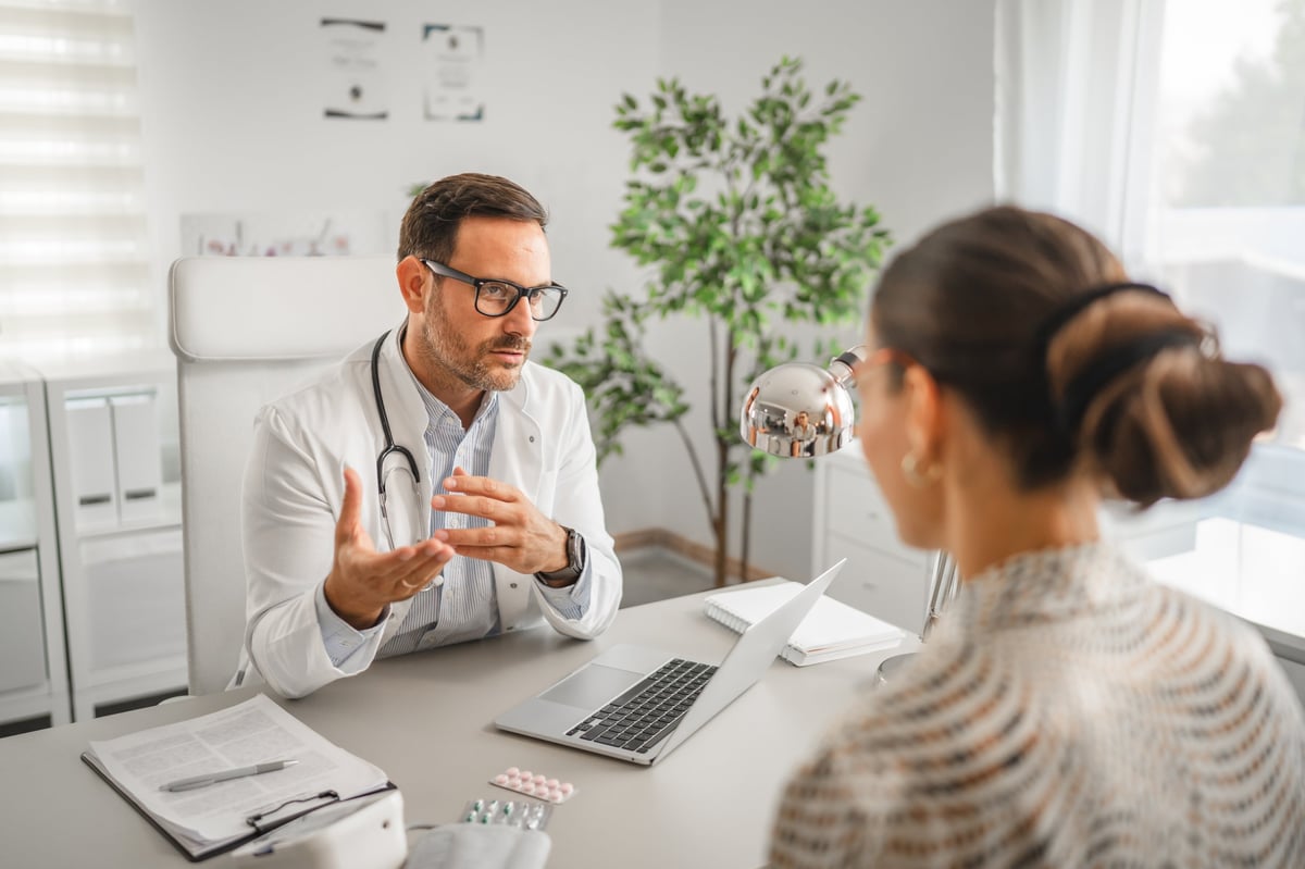 Doctor consulting with patient in bright modern clinic